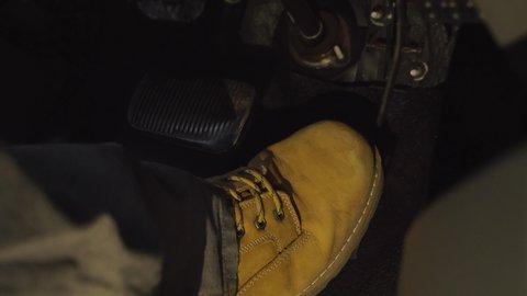 Big tan boot of male driving and abruptly switching from gas to brake pedal close up 4k