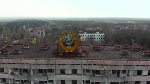 Pripyat aerial panorama cityview over the sign of USSR on the roof of building. Soviet coat of arms on a high-rise building in Pripyat, view from above.