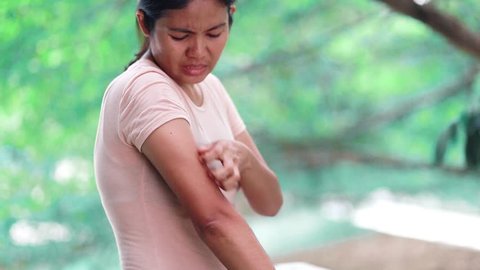 Young Asian Woman with itching from biting insect in arm , Concept with Healthcare And Medicine