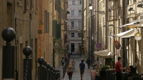 Italy, Rome - September, 2016: People walking on a narrow street in Rome.