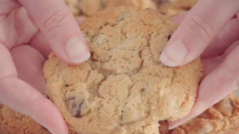 SLOWMO CLOSE UP, Breaking chocolate chip cookie in half revealing inside texture