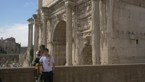 Italy, Rome - September, 2016: Couple taking pictures near the Arch of Septimius Severus (Arco di Settimio Severo) in Rome.