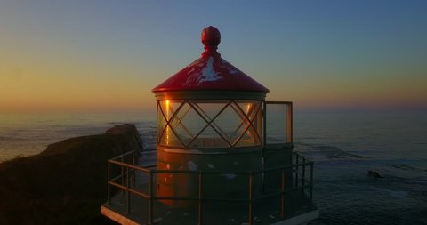 Lighthouse at Cape Arago During Sunset - Oregon, USA - Rotating Aerial View