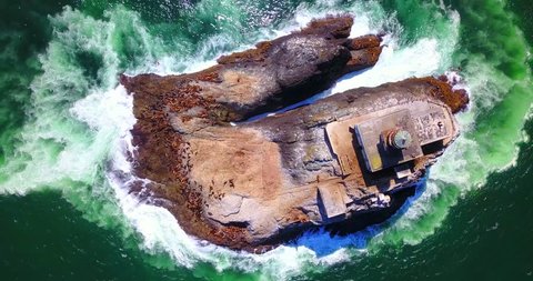 Overhead View of Rock Island With Lighthouse and Seals on Shore with Green Frothy Surf - Tillamook Rock, Oregon, USA 