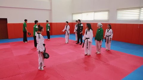 Adult trainer is training teenagers in karate class/ Ankara,TURKEY 01.03.2016
