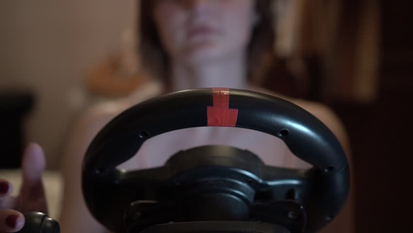 girl playing car simulator in home