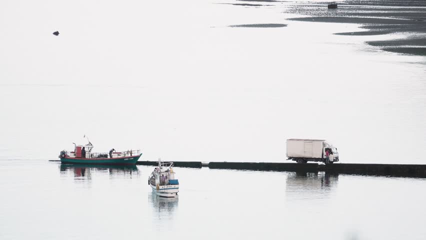 Truck parked on the port waiting for unload of commercial goods to transfer to the city