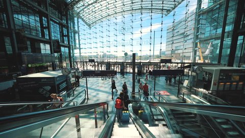 Berlin, Germany - April 25, 2019: Berlin  Hauptbahnhof (central railway station), Passengers moving up and down with escalator through main railway station Berlin Hauptbahnhof.