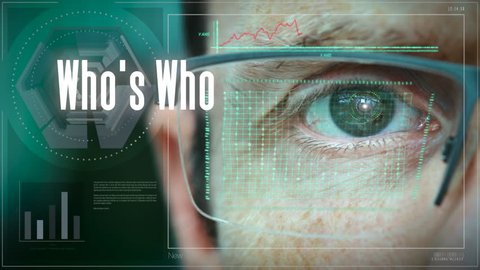 A close up of a businessman eye controlling a futuristic computer system with a Who’s Who Business concept.