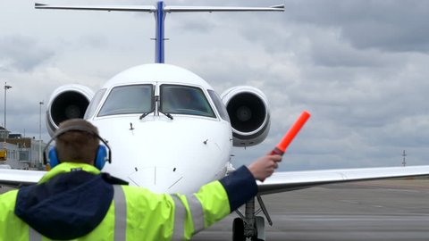 Airport Air Marshaller Signalling Executive Jet Pilot.
