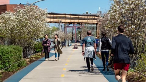 Hyper lapse of people walking and exercising on The 606 Bloomingdale Trail in Chicago, Illinois on April 26, 2019:.