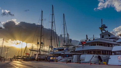 NAFPLIO,GREECE, 08 MAY 2019 : 4K Timelapse of yachts and motor boats over the blue cloudy sky in Nafplio city harbor, Greece