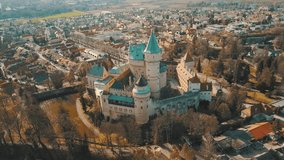 Aerial View beautiful landscape on Bojnice castle in city, mountains background in summer sunny day with blue sky, Drone 4K Video
