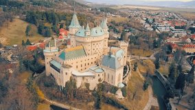 Aerial View beautiful landscape on Bojnice castle in city, mountains background in summer sunny day with blue sky, Drone 4K Video
