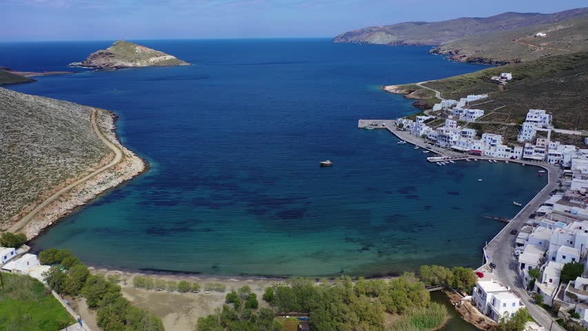 Aerial drone video of picturesque beautiful fishing village and small harbour of Panormos, Tinos island, Cyclades, Greece