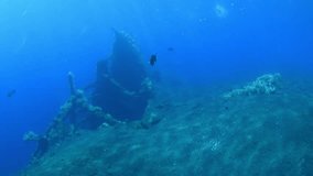 Sunken ship near the coast of Bali. World War II. Artificial reefs and coral gardens - fantastic underwater world. Diving and snorkeling in Bali.
