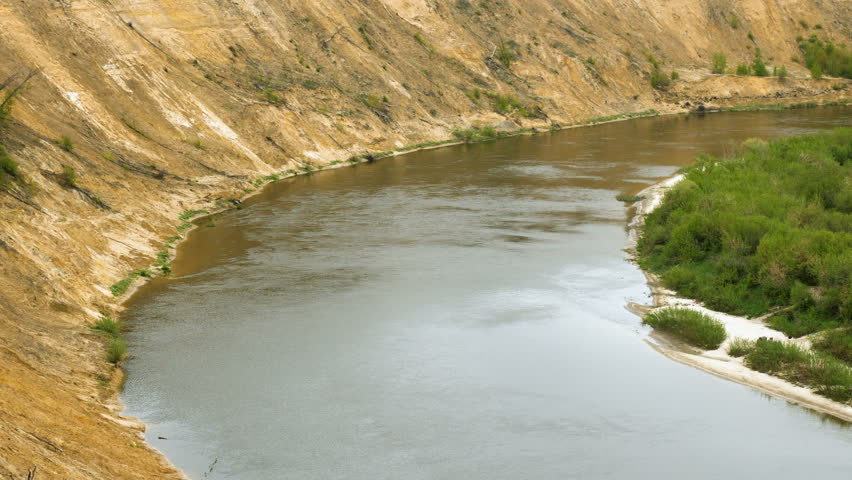 Scenic landscape. River flowing through the forest and fields. 4K
