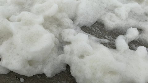 Close up of moving and blowing sea foam
