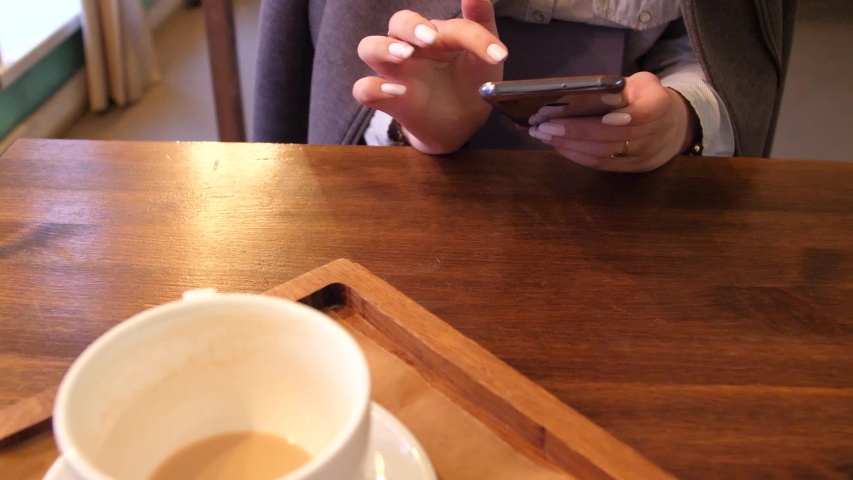 girl texting at social network in cafe