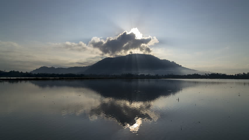 Timelapse sunray over reflection paddy field during watering season.