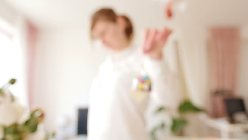 Young Caucasian woman giving presenting sweet multicolored heart shape bonbons - shot in slow motion for holidays presentations, advertising
