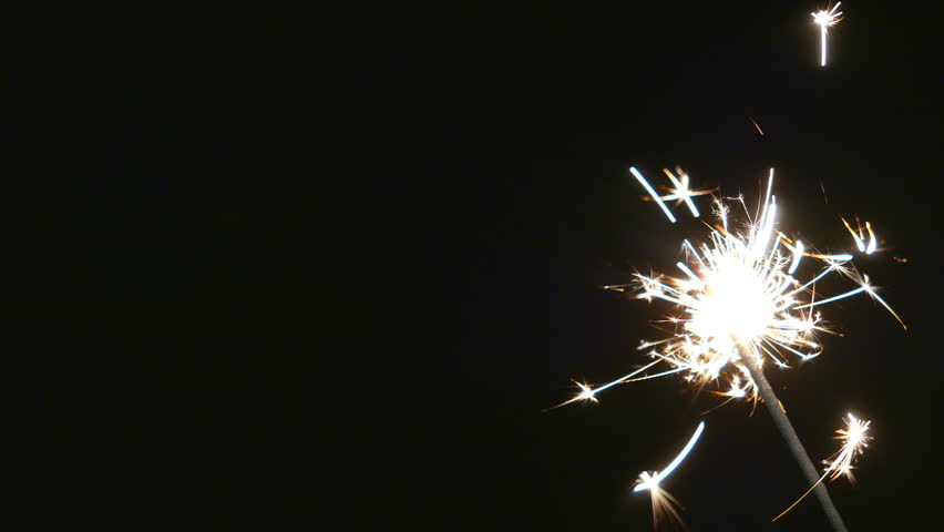 Firework Flame Sparkler Hand Held Burning Down Sparks in Black Background and Surrounding