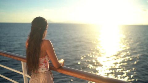 Cruise ship vacation travel woman enjoying sunset at sea on boat with beautiful sunset on travel at on the ocean