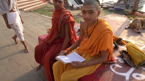 Varanasi / India 23 April 2019 Students of Sanskrit Gurukul in saffron costume sitting near the holy river ganga on Varanasi Ghat of Uttar Pradesh 