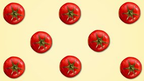 Abstract color animation of tomatos on pastel yellow background. 4K seamless loop clip art vegetable footage.