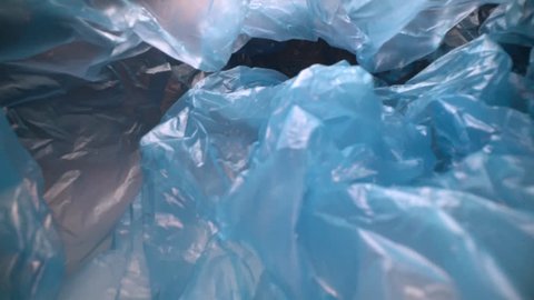 Dolly shot through disposable plastic bag background. Transparent, reusable plastic waste. Plastic recycling, environmental issues
