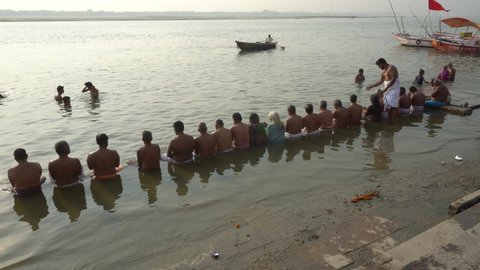 Varanasi / India 23 April 2019 Devotees from South India perform rituals for the salvation of their ancestors at the banks of sacred river Ganges in holy city Varanasi Uttar Pradesh 