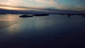 Ice skating over sea ice at Naantali, Finland. Colorful drone footage.