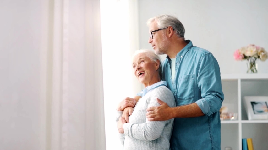 relationships, old age and people concept - happy senior couple hugging at home Royalty-Free Stock Footage #1029274217