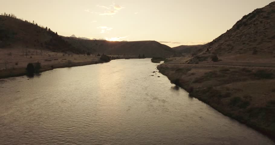 Twilight zone time of Madison River next to the highway at golden hour time (drone shot)