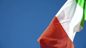 Italian flag flying on the blue sky. Flag of Italy. Slow Motion. - Powered by Shutterstock - Get 15% off with code: PIKWIZARD15