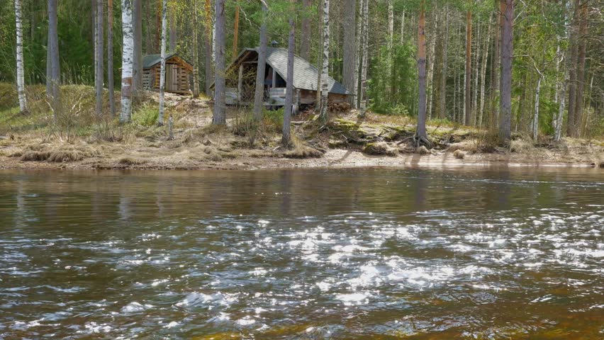 Lean in sunny weather by the river. The rays of the sun glitter with waves 4k