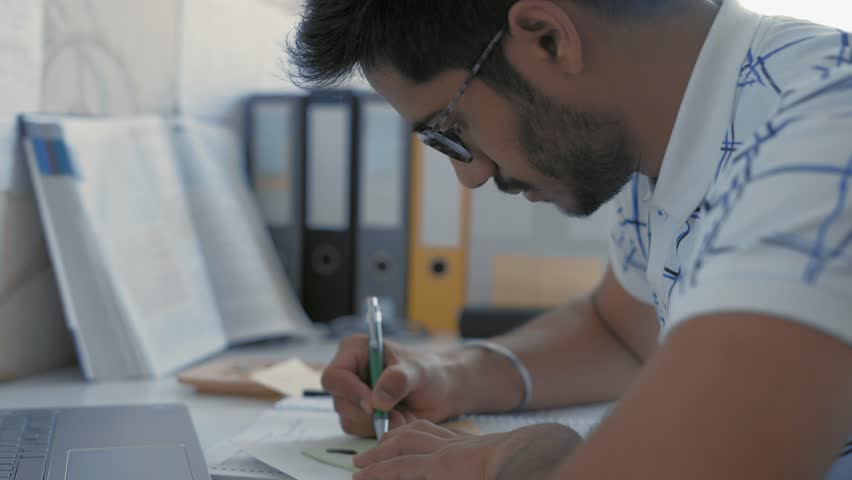 Close-up, Indian Student in Glasses Makes Sketching on Sticker, Prepares for the Medecine Exam