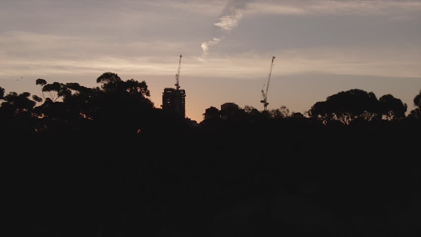 Various aerial shots of Adelaide city near sunset. Lens flare and airplane visible in some. South Australia.