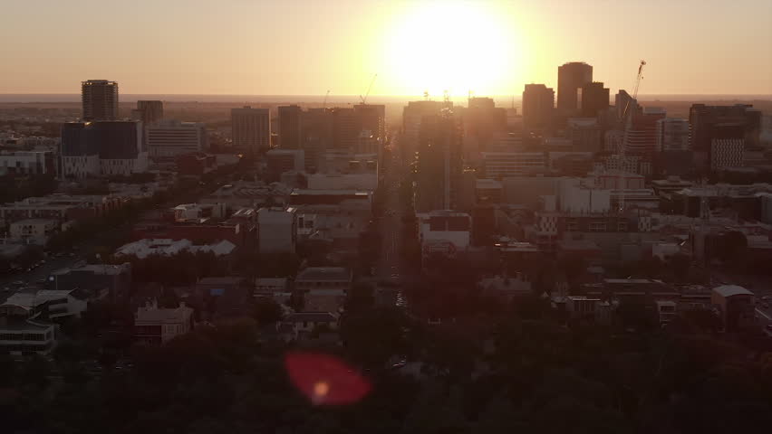 Various aerial shots of Adelaide city near sunset. Lens flare and airplane visible in some. South Australia.
