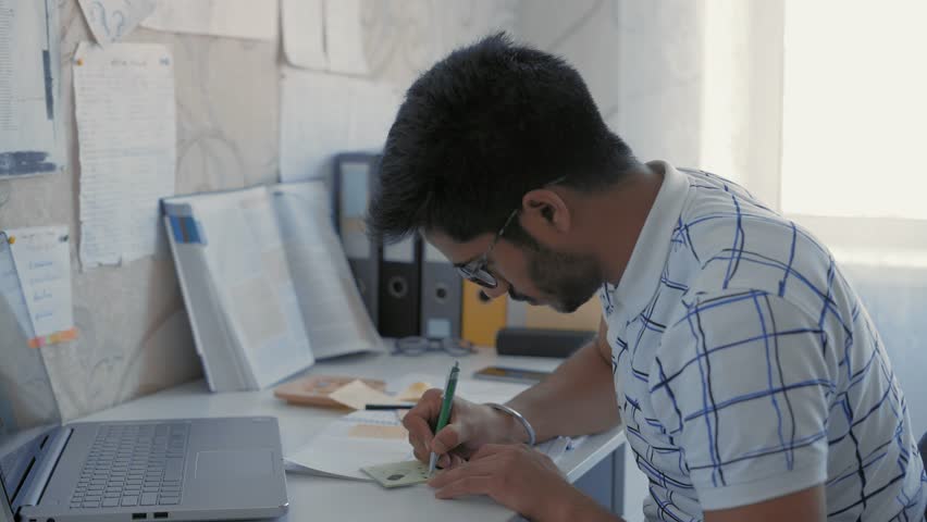 Close-Up, Indian Student Makes a Sketch on a Sticker, Prepares a Cheat Sheet for a Medecin Exam