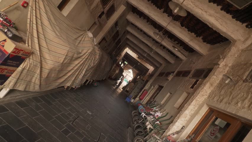 Smooth slow-motion roll camera movement through Souq Waqif in Doha, Qatar
