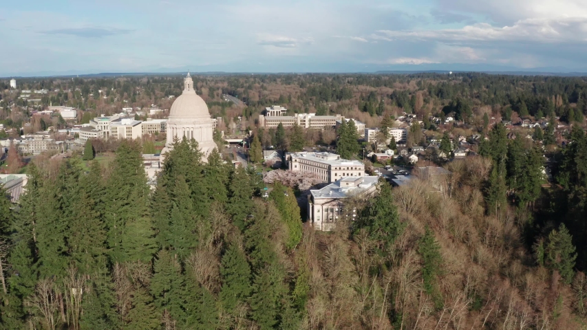 Wahington state capitol building and surrounding buildings, lake and park in Olympia.