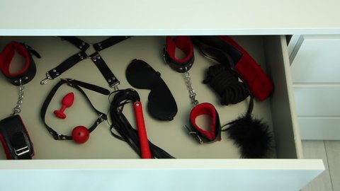 Chest with gag, handcuffs, bandage and whip. BDSM sex toys, erotic entertainment for adults