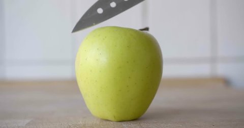 Cutting a green apple in the kitchen.