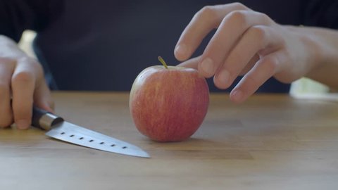 Cutting an apple in pieces.
