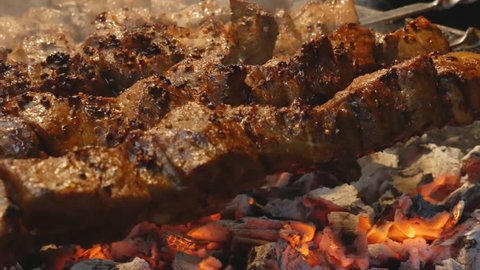 cooking juicy meat on the grill. Steak, shish kebab. delicious Fried slices of pork or lamb.