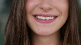 Close up shot of pretty young Caucasian womans mouth looking at camera, smiling. Lifestyle concept 