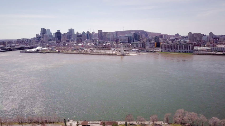 Static drone / aerial footage showing the Old Port (Vieux Port) of Montreal and downtown from above the Saint Laurent River during fall season.