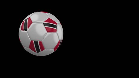 Soccer ball with the flag of Trinidad and Tobago flies past the camera, slow motion, 4k footage with alpha channel