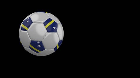 Soccer ball with the flag of Curacao flies past the camera, slow motion, 4k footage with alpha channel